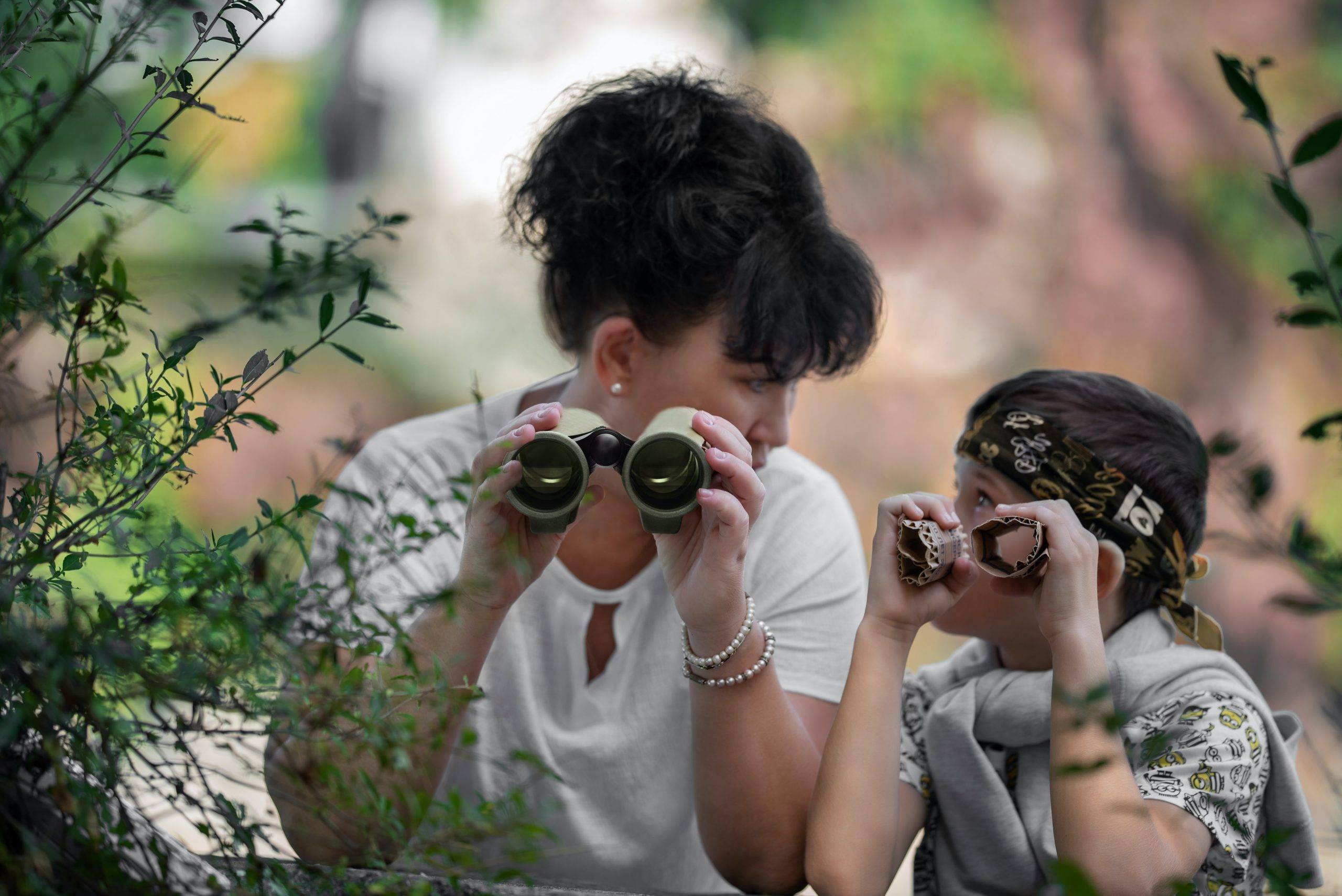 Developing keen observation skills mother and child observing the world through binoculars