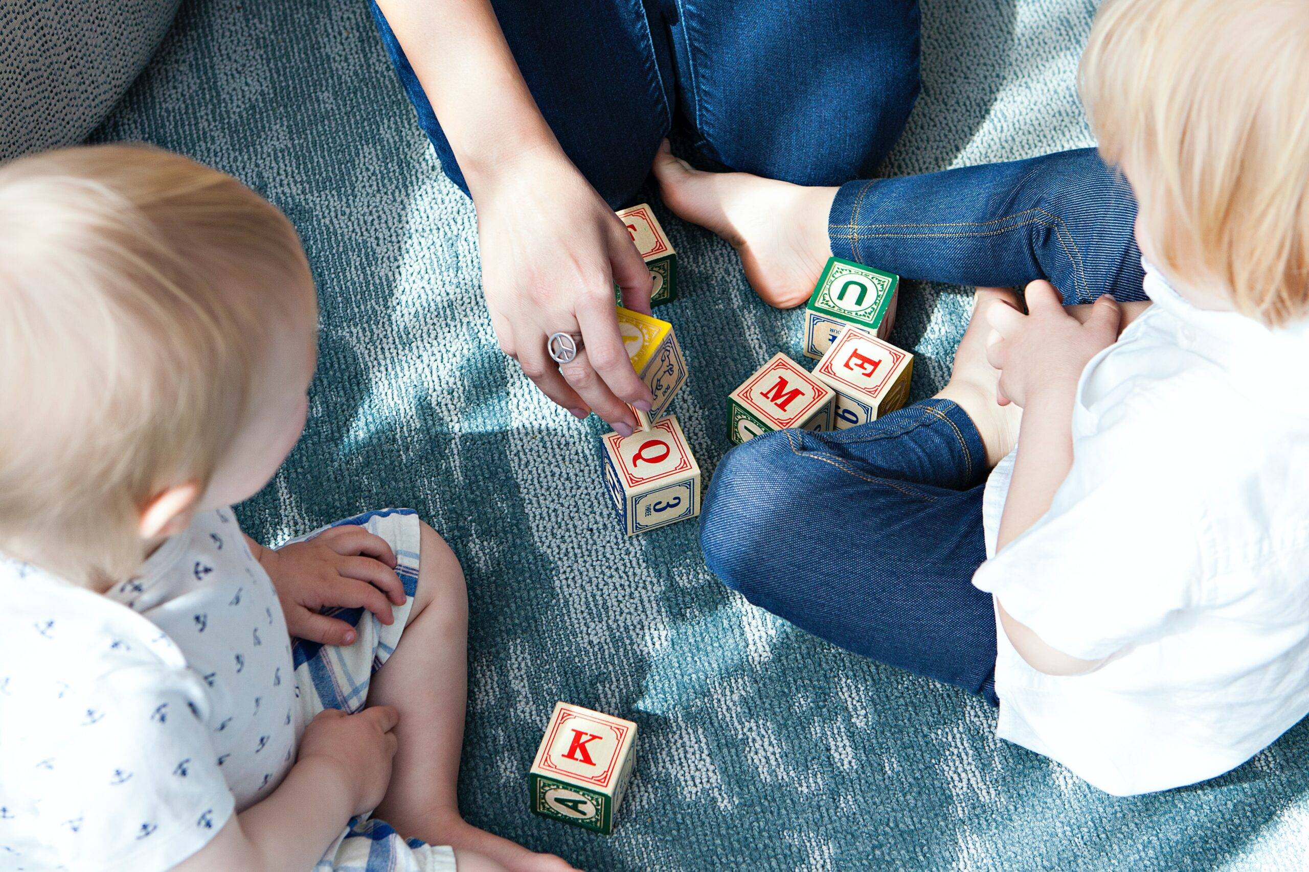 Mum and small kids playing with blocks